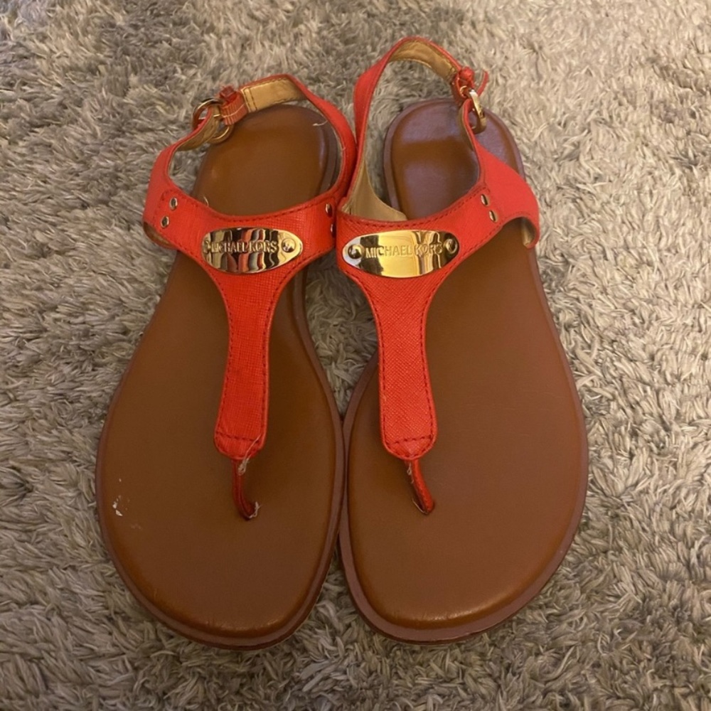 Women’s Micheal Kor’s orange sandals with gold plate. Size 7. Slightly worn